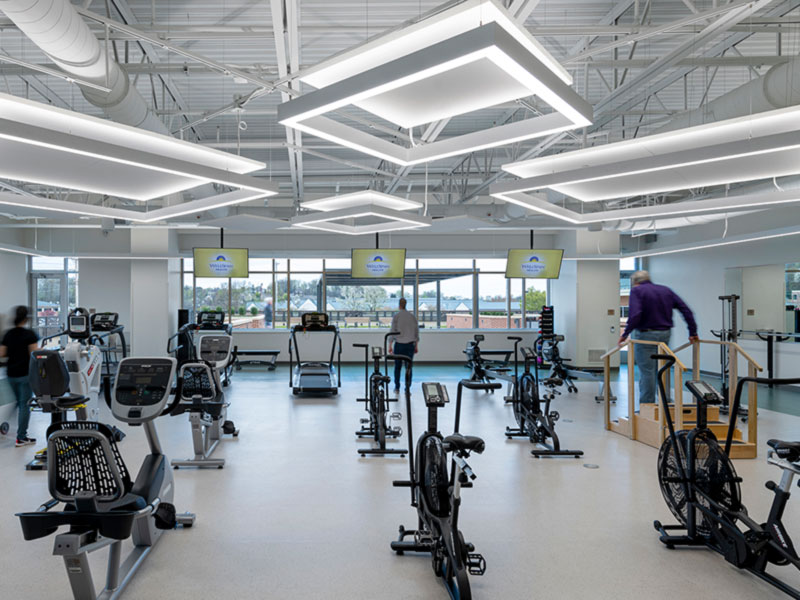 Cardiac rehabilitation gym with exercise equipment and suspended LED lighting at WellSpan Heart and Vascular Center