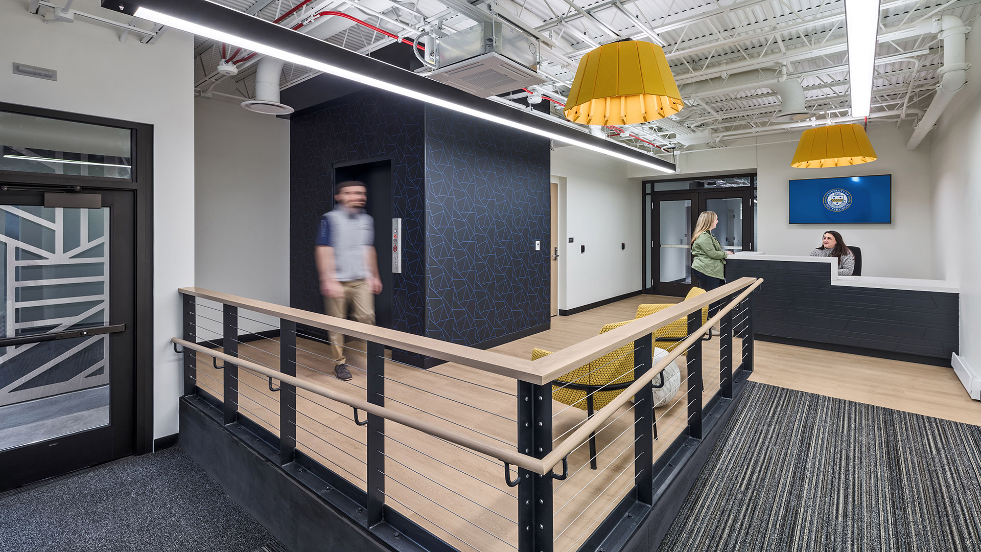 Renovated School of Computing and Information lobby at University of Pittsburgh with modern collaborative workspace