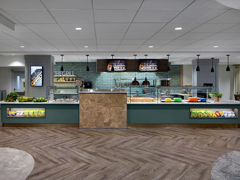 Upgraded café serving area at Kendal at Longwood with new kitchen equipment, food service counters, and mechanical and electrical system improvements