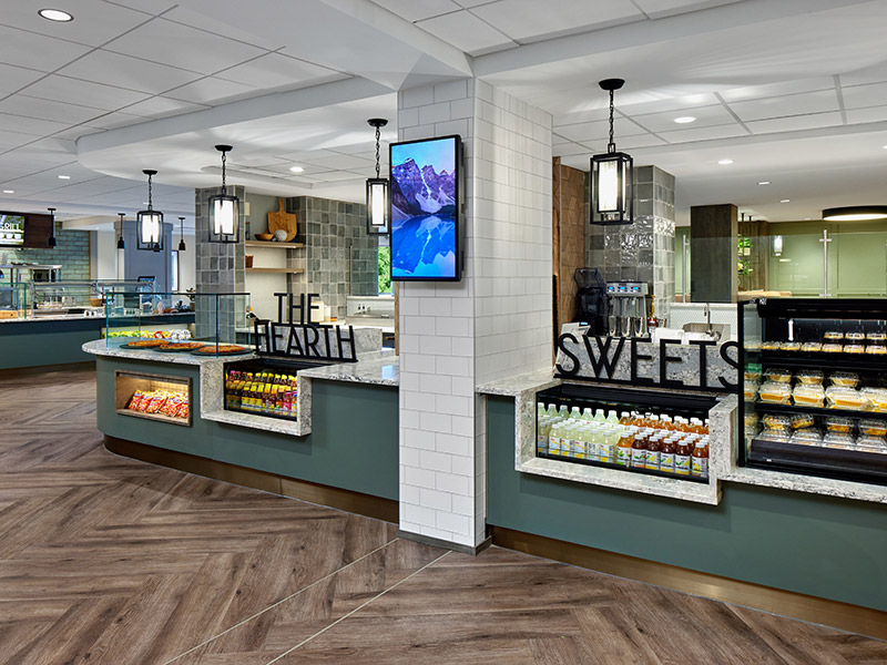 Renovated café market area at Kendal at Longwood featuring refreshed food stations and beverage service