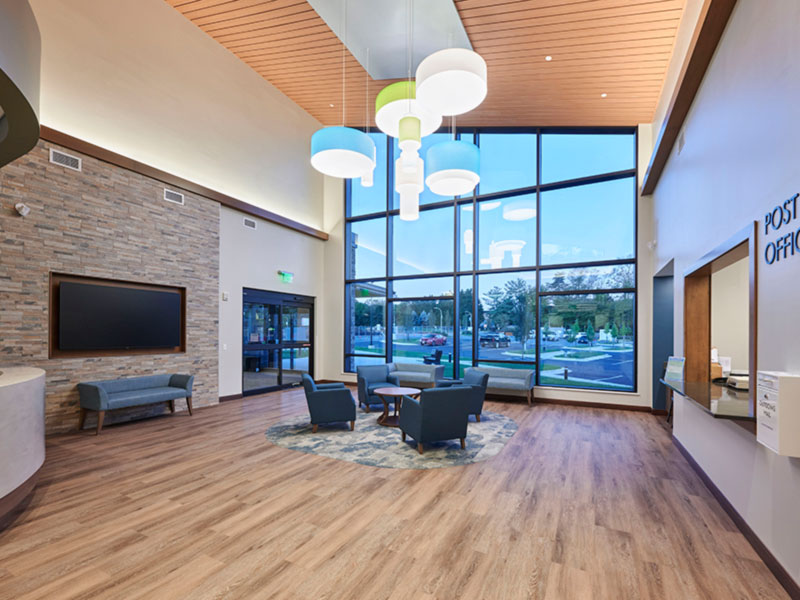 Lobby interior of Leisure World Administration Building with seating area and post office