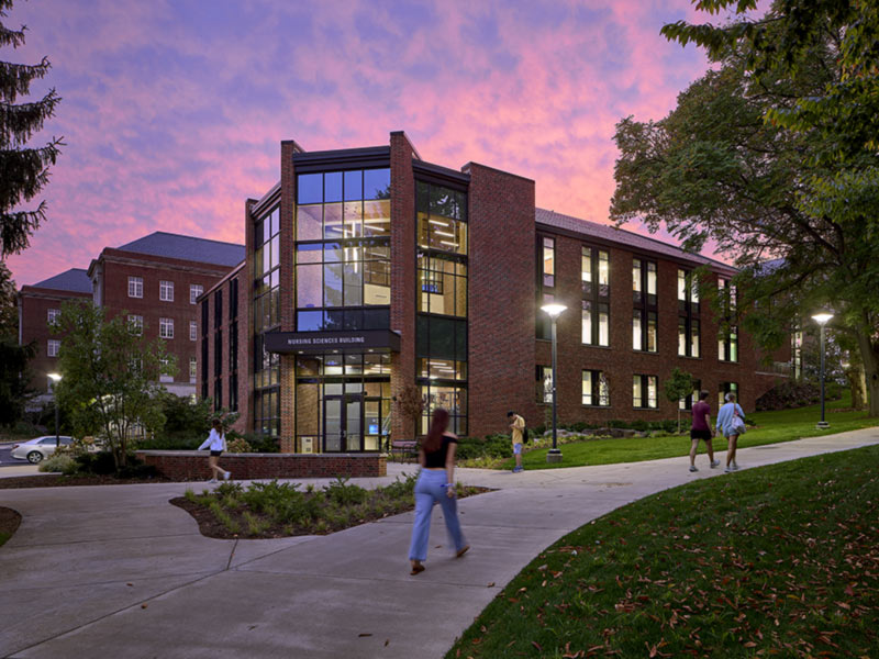 Penn State College of Nursing building at dusk following renovation and expansion