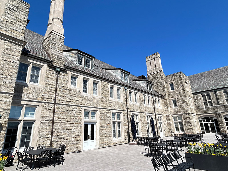 Renovated stone apartment buildings at Masonic Village in Elizabethtown, PA with updated courtyard and outdoor seating