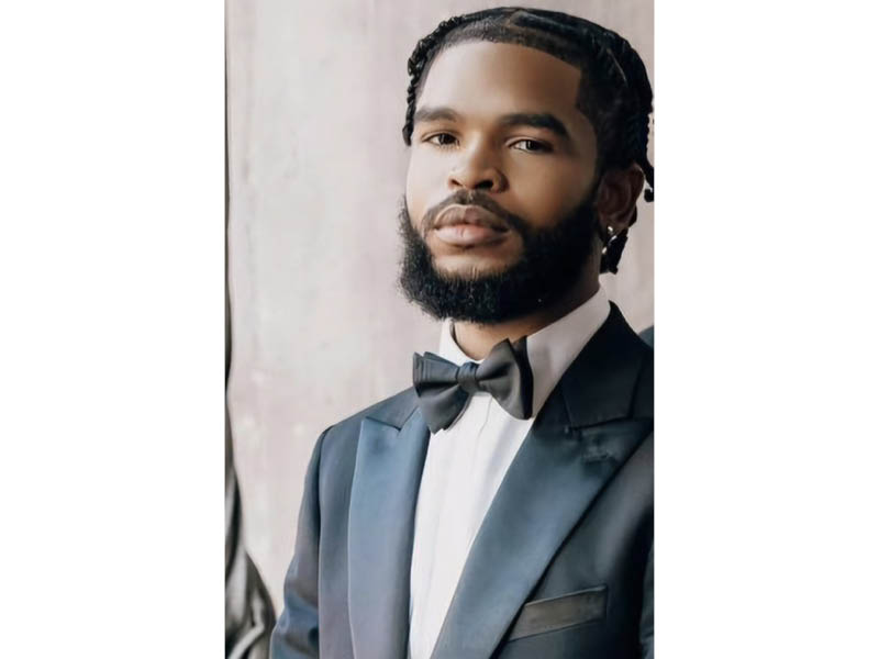 Okein R. Miller wearing a suit and tie. 