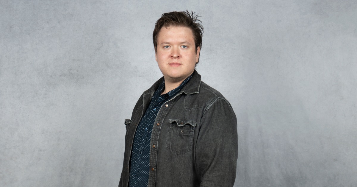 Samuel D. Johnson, Information Technology Support Specialist at Barton Associates, professional portrait in front of a gray background.